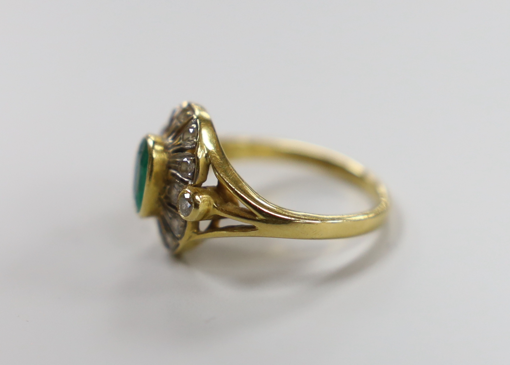 An 18ct gold emerald and diamond cluster ring, size M, gross 4.5 grams
